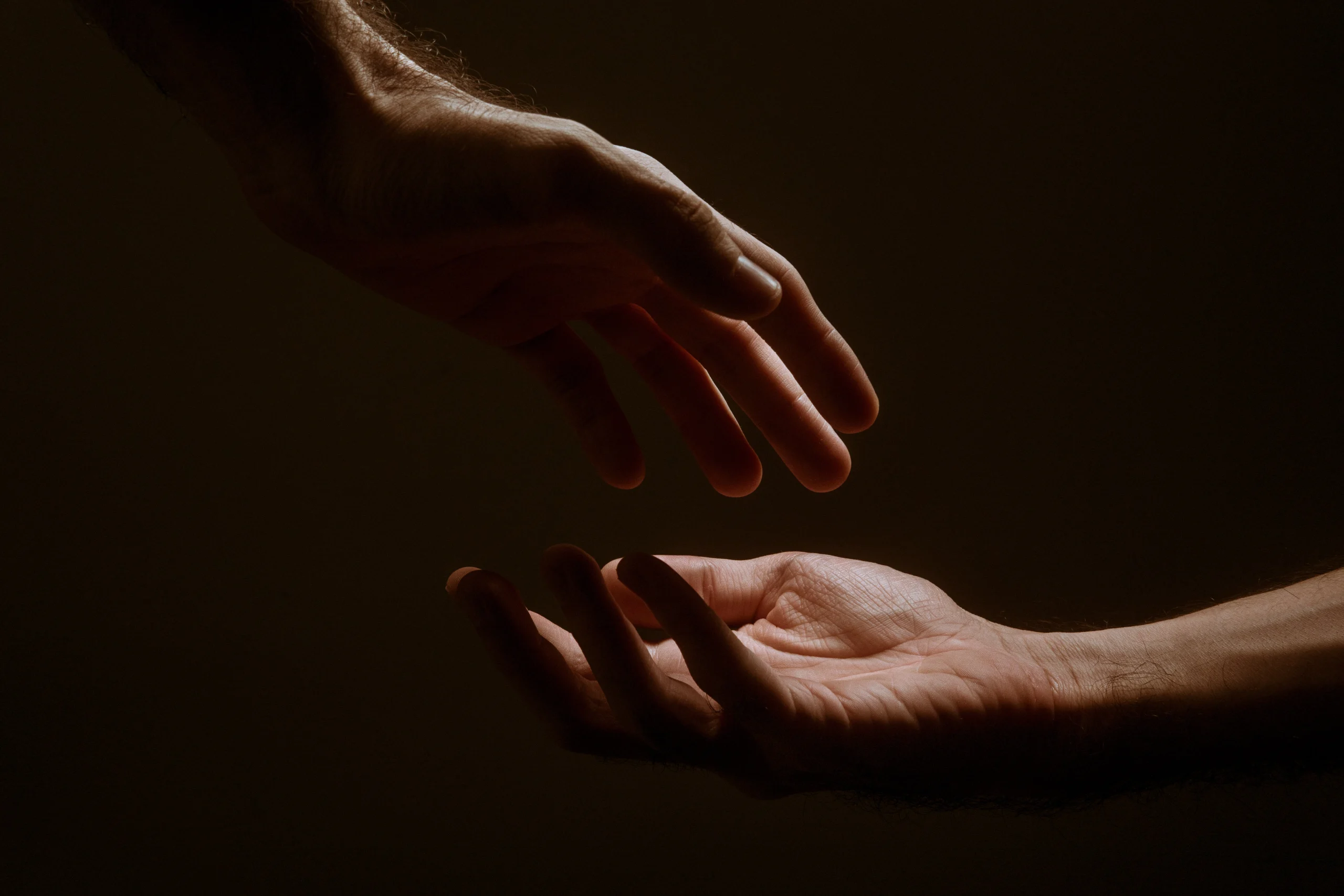 Hands reaching out for one another